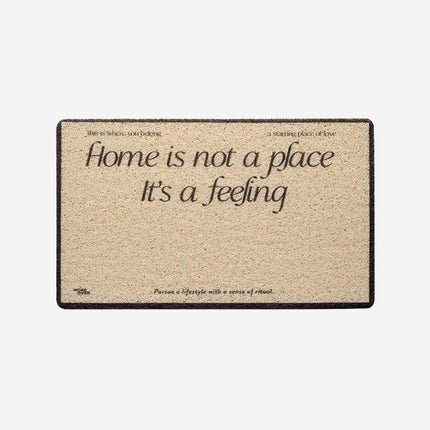 Deurmat met tekst 'Home is a feeling'