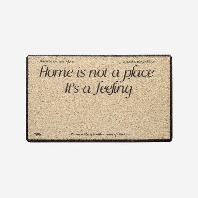 Deurmat met tekst 'Home is a feeling'