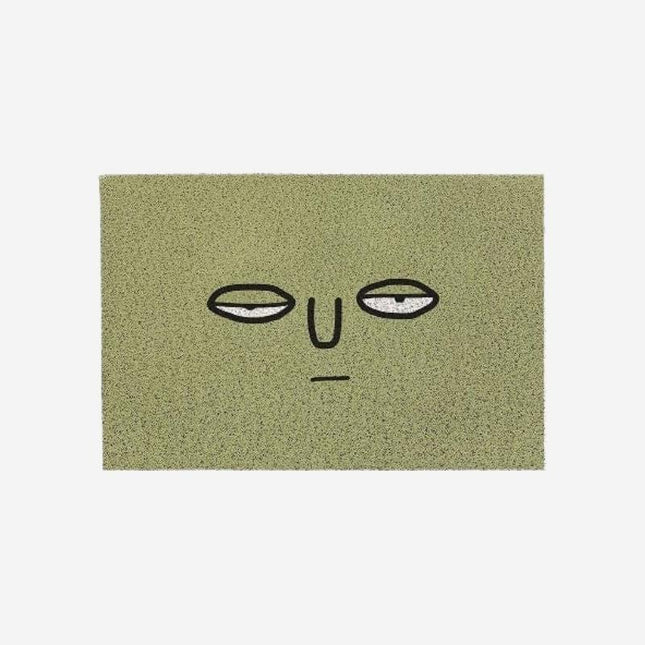 Grappige groene deurmat met gezicht