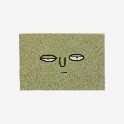 Grappige groene deurmat met gezicht