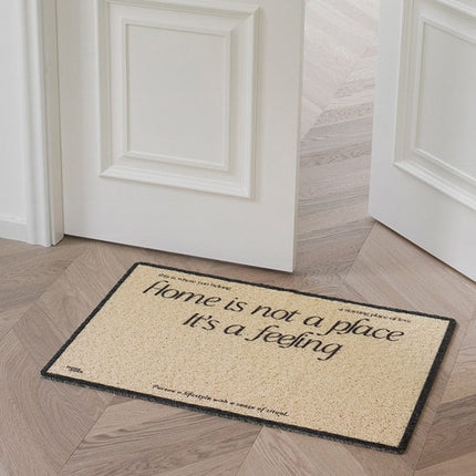 Deurmat met tekst 'Home is a feeling'